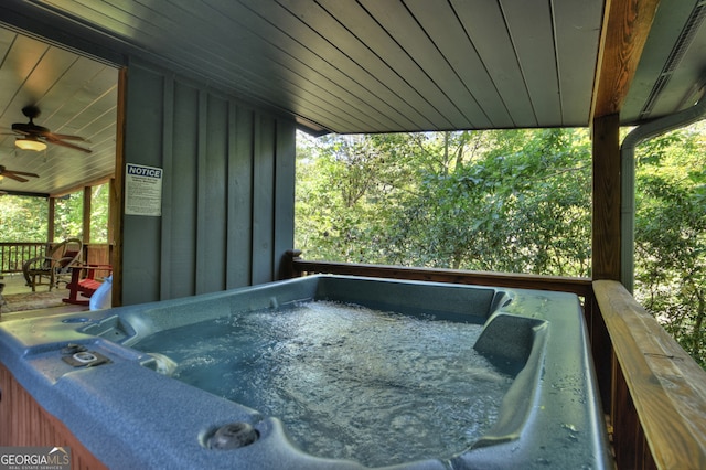 deck featuring a hot tub and ceiling fan