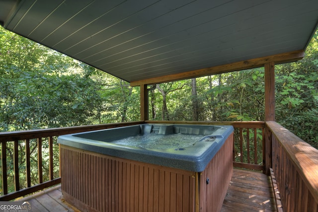 wooden deck with a hot tub