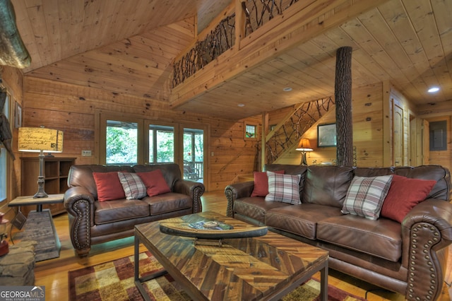 living room featuring light wood-type flooring, wood walls, wood ceiling, and high vaulted ceiling