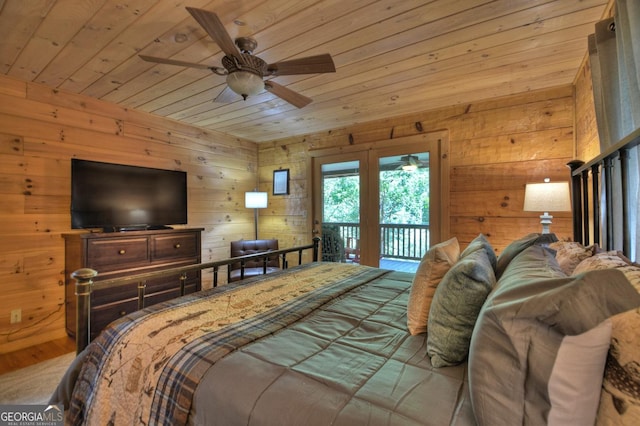 bedroom featuring access to outside, wooden ceiling, wood walls, and wood finished floors