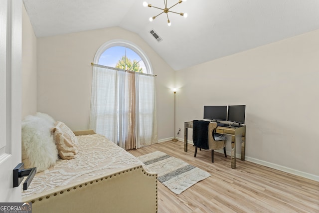 bedroom with lofted ceiling, a chandelier, and light hardwood / wood-style floors