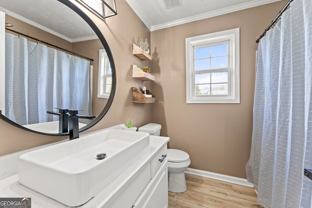 bathroom featuring crown molding, vanity, toilet, and wood-type flooring