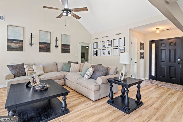 living room with ceiling fan, high vaulted ceiling, and light hardwood / wood-style floors