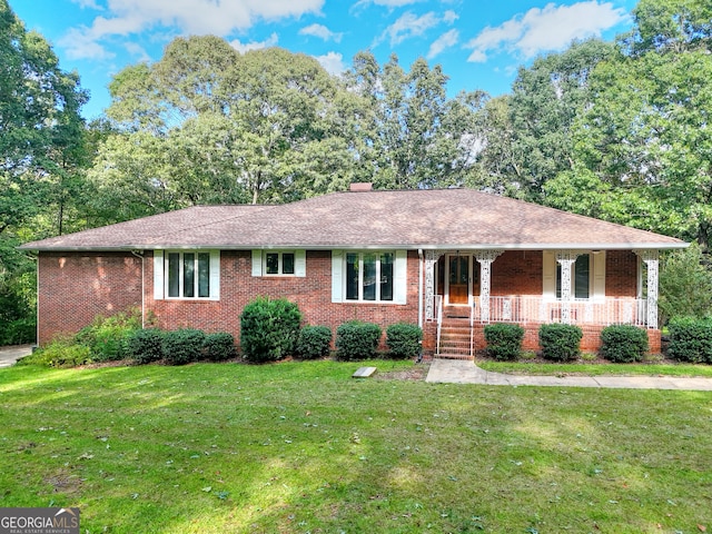 ranch-style house with a porch and a front lawn