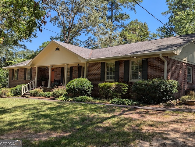 single story home featuring a front yard and covered porch