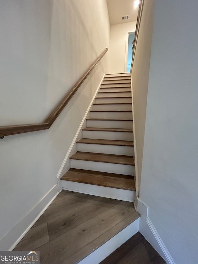 stairway featuring hardwood / wood-style flooring