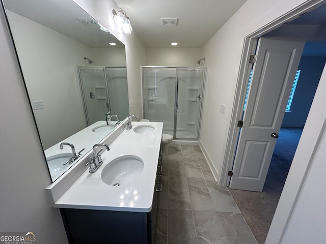 bathroom with a shower with shower door, toilet, and vanity