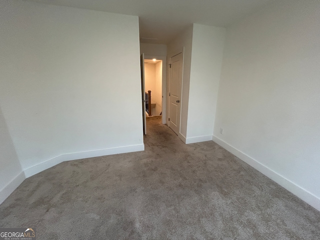 unfurnished room with light carpet