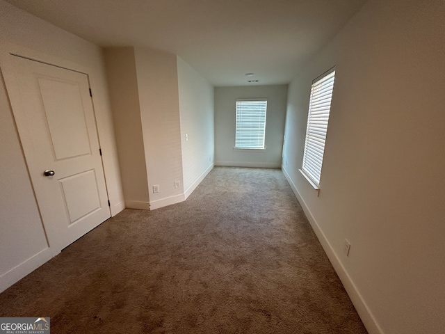 corridor with carpet flooring