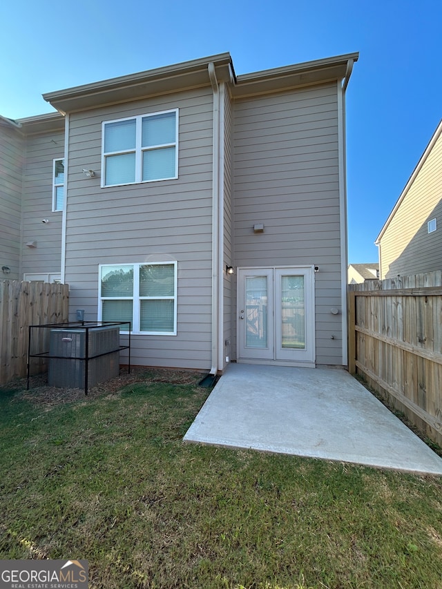 rear view of house with a patio area and a lawn