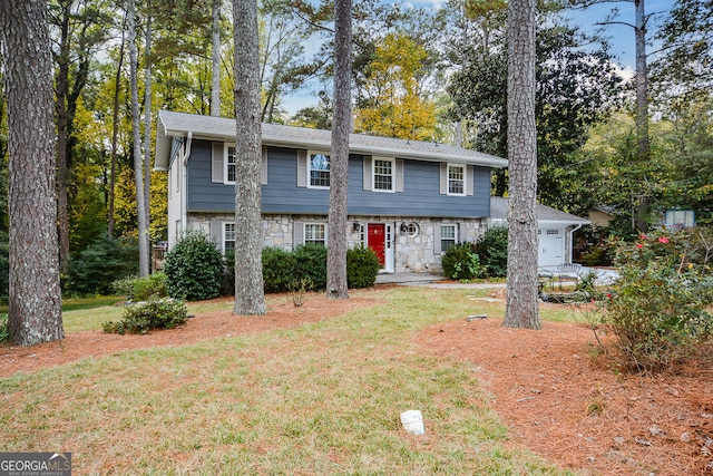 view of front of home featuring a front yard and a garage