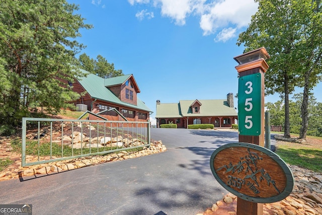 view of home's community featuring aphalt driveway