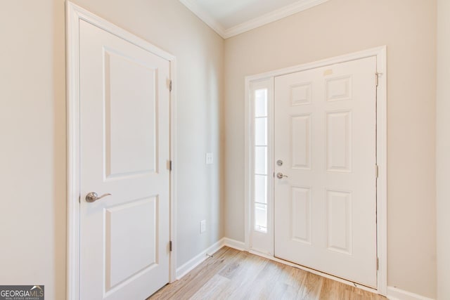 foyer featuring light wood-type flooring and ornamental molding