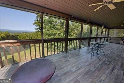 wooden terrace featuring ceiling fan