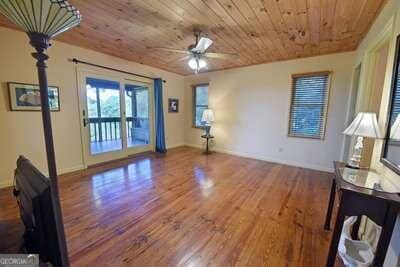 interior space featuring wood ceiling, wood-type flooring, and ceiling fan