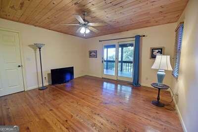 unfurnished living room with ceiling fan, hardwood / wood-style floors, and wooden ceiling