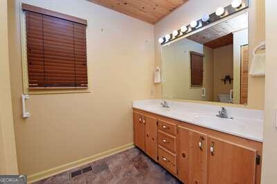 bathroom with vanity, toilet, and wooden ceiling