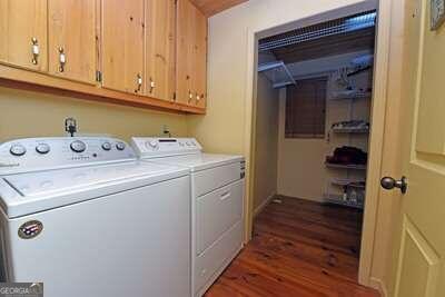 laundry area with cabinets, dark hardwood / wood-style floors, and independent washer and dryer