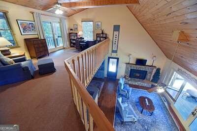 living room with wood ceiling, ceiling fan, and vaulted ceiling with beams