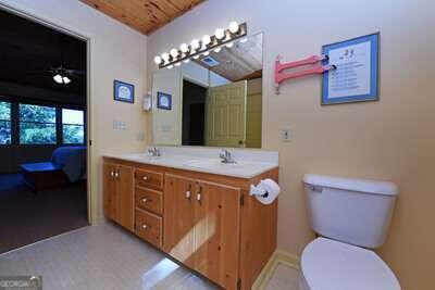 bathroom featuring wood ceiling, vanity, toilet, and ceiling fan