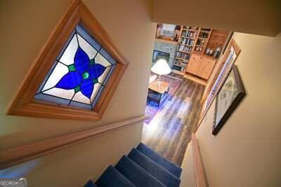 stairs with hardwood / wood-style flooring