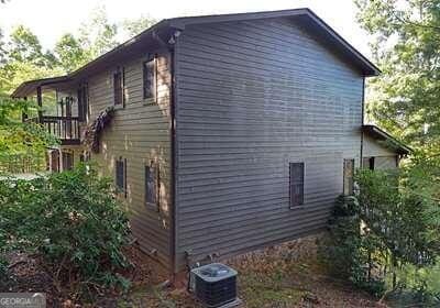 view of side of property with central air condition unit