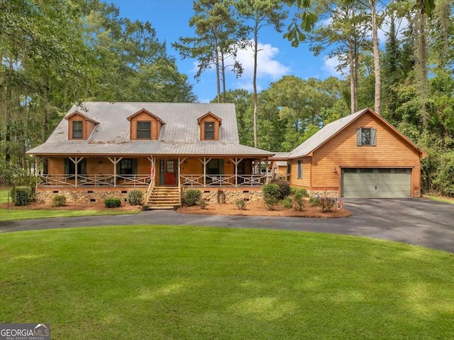 view of front of house featuring a porch, a garage, and a front lawn