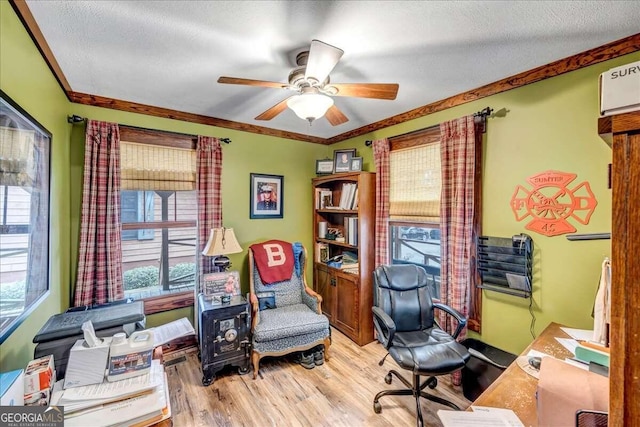 office with ceiling fan, ornamental molding, a textured ceiling, and light hardwood / wood-style flooring