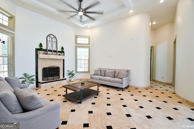 tiled living room with a towering ceiling and ceiling fan