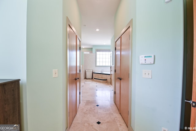 hall with light tile patterned floors