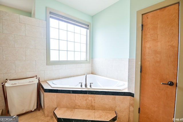 bathroom with tile patterned flooring, tiled bath, toilet, and tile walls