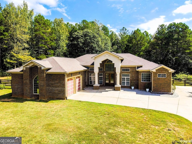 view of front of house featuring a garage and a front lawn