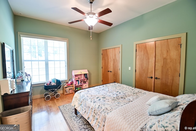 bedroom with light hardwood / wood-style floors and ceiling fan