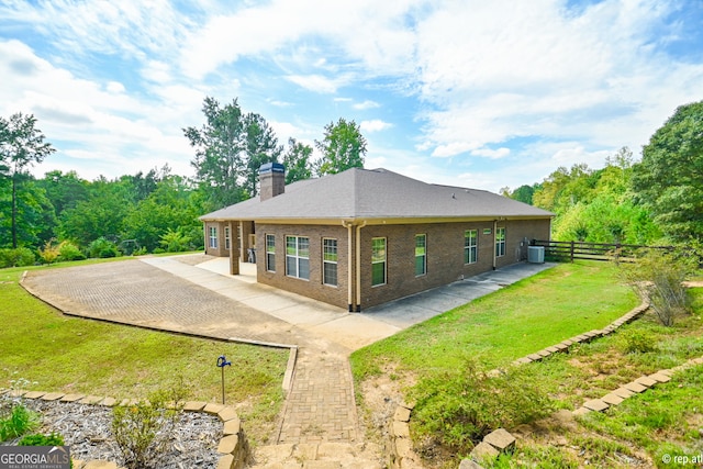 back of property featuring a lawn