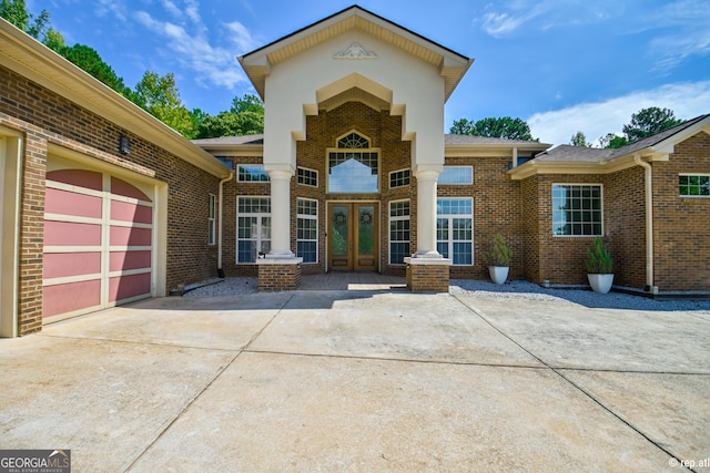 view of front of home with a garage and french doors