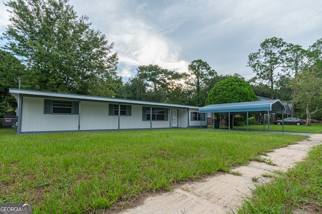 ranch-style house featuring a carport and a front lawn