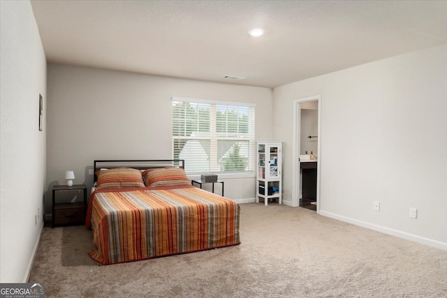 carpeted bedroom with ensuite bath