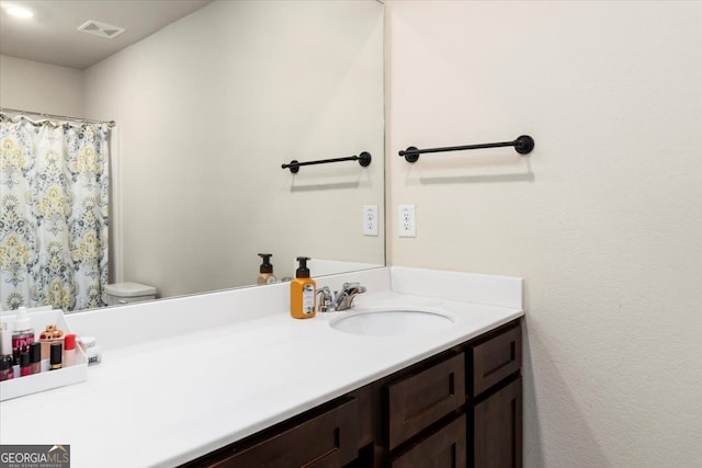 bathroom featuring vanity and toilet