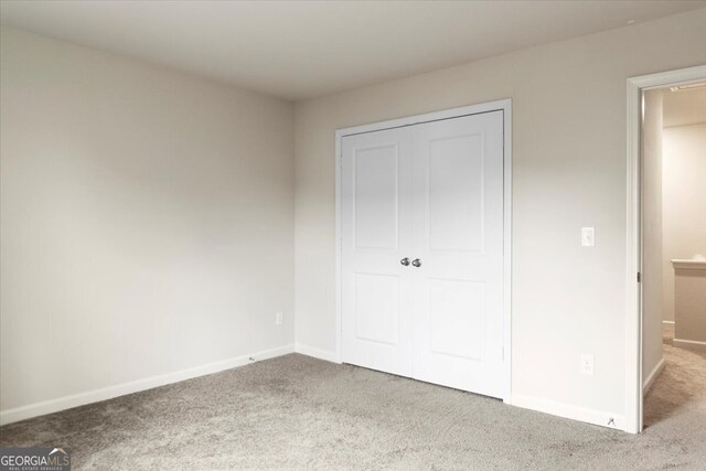 unfurnished bedroom with light colored carpet