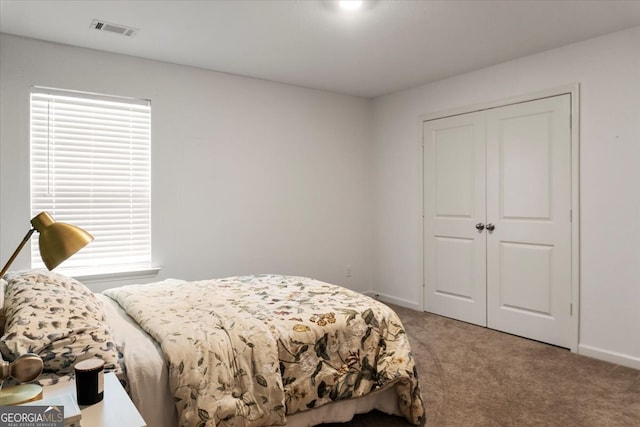 carpeted bedroom with a closet