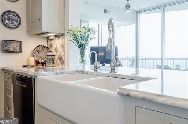 kitchen featuring dishwasher, white cabinets, light stone counters, and ceiling fan