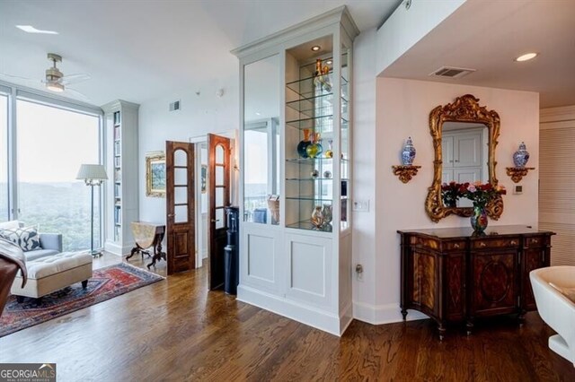 living room featuring hardwood / wood-style floors, ceiling fan, and floor to ceiling windows