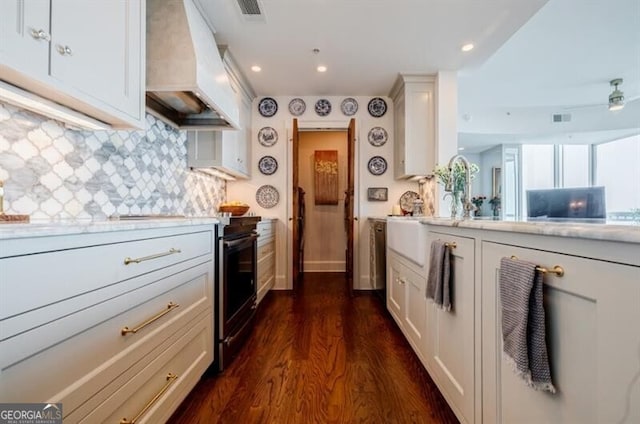 kitchen featuring backsplash, white cabinetry, dark hardwood / wood-style floors, and custom range hood