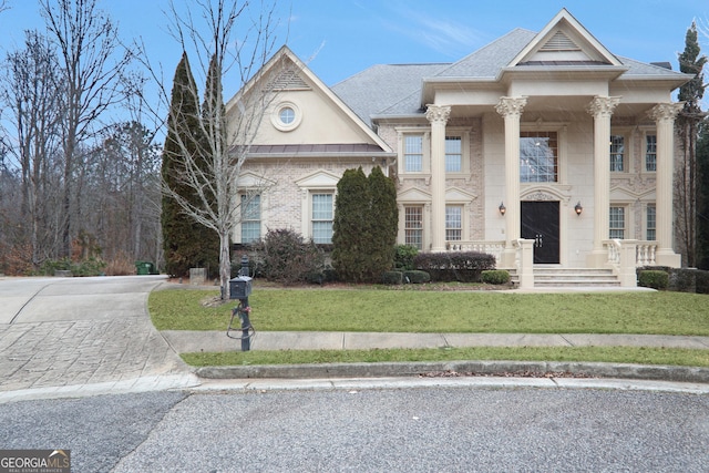 greek revival house featuring a front lawn