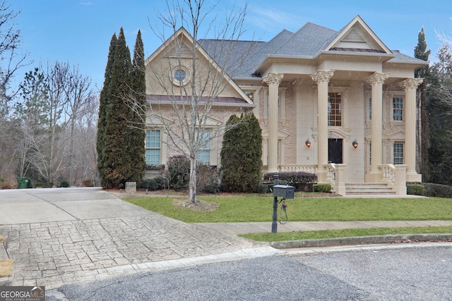 greek revival inspired property with a front lawn