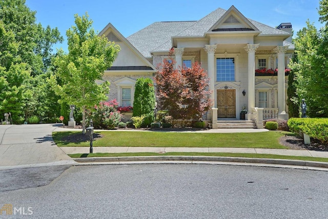 neoclassical home with a front yard