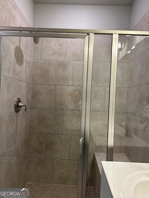 bathroom with an enclosed shower and vanity