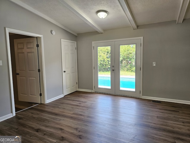 unfurnished room with french doors, a textured ceiling, vaulted ceiling with beams, and dark hardwood / wood-style floors