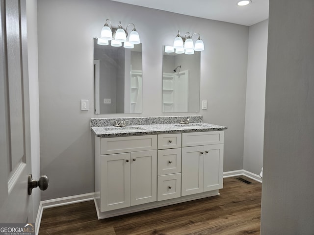 bathroom with vanity and hardwood / wood-style floors