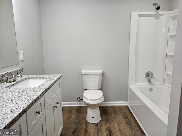 full bathroom featuring vanity, hardwood / wood-style floors, toilet, and shower / bath combination